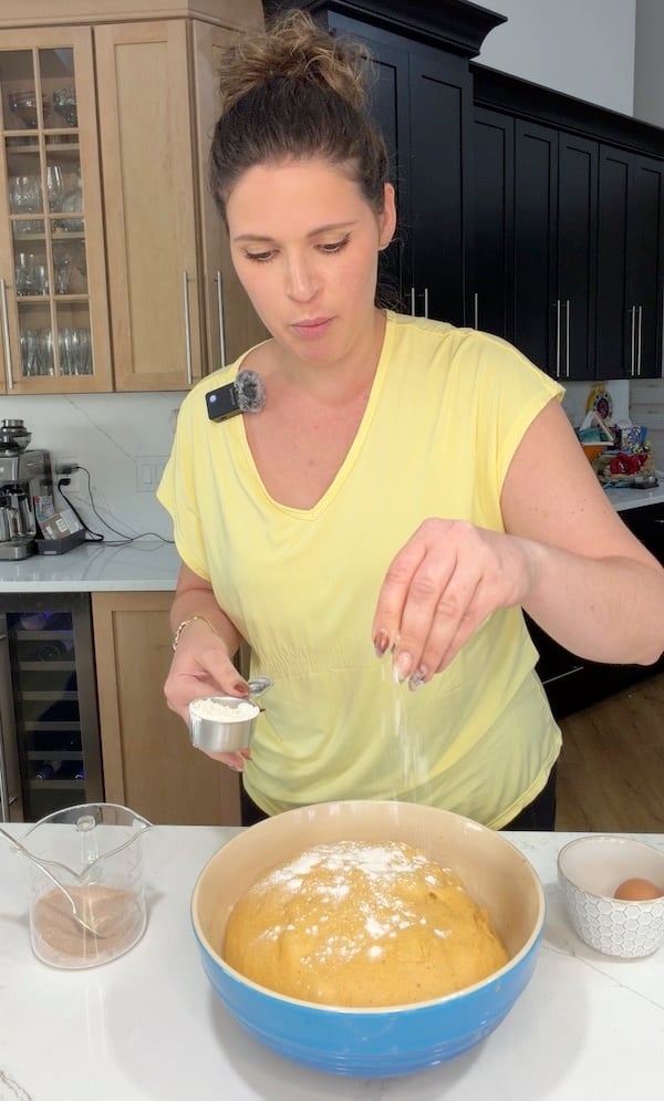 adding flour to tacky dough