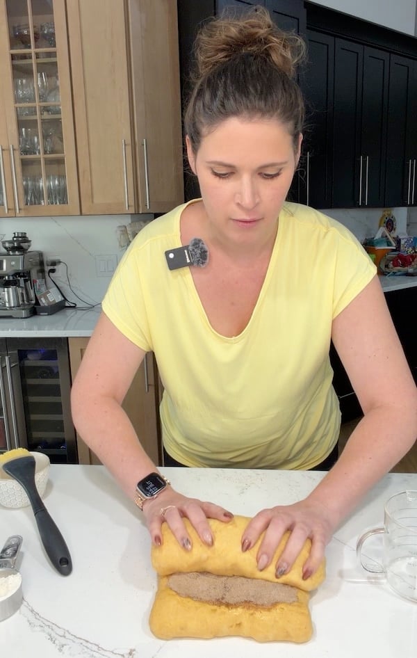 rolling up pumpkin swirl dough