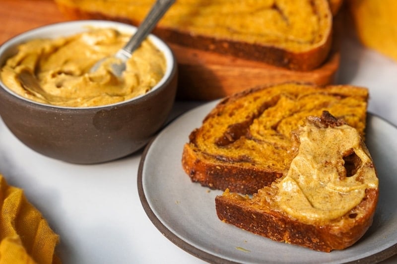 small plate with pumpkin sourdough bread slices with pumpkin butter