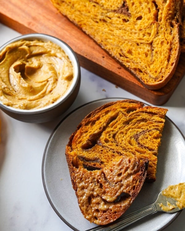 toasted pumpkin sourdough bread with melted pumpkin butter on top